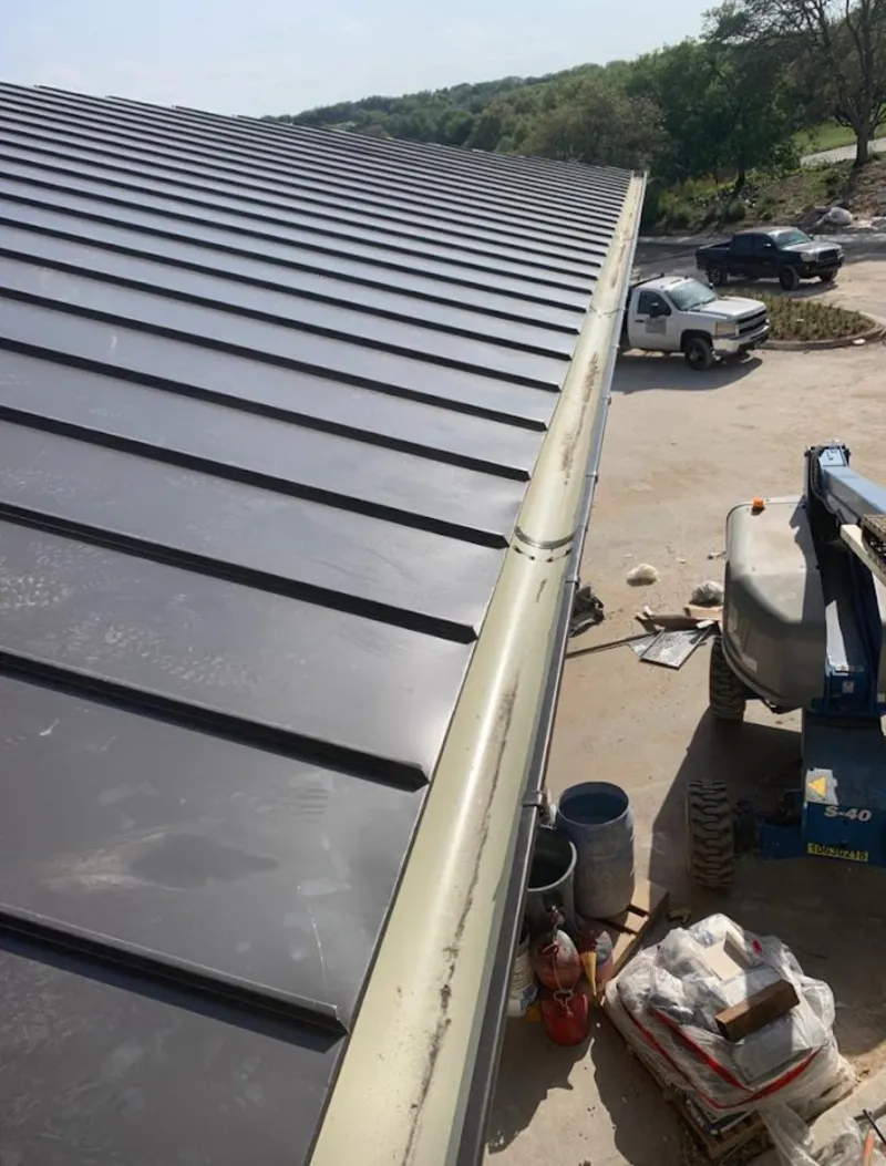 Standing seam panel and gutter detail on a metal roofing jobsite in Lake Goodwin
